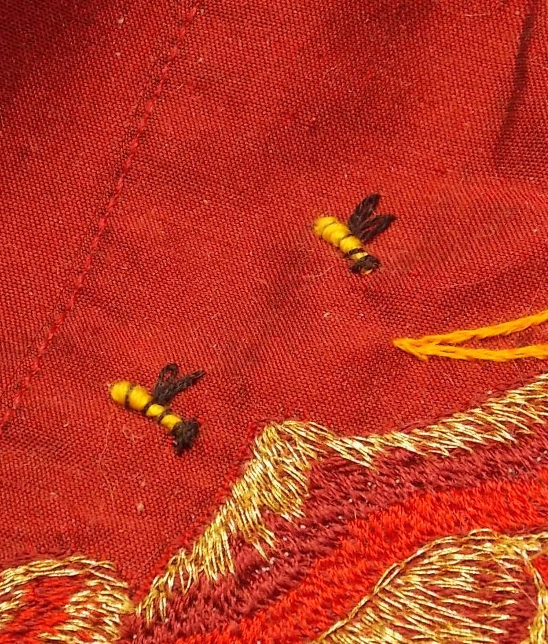 embroidered bees on the red dress